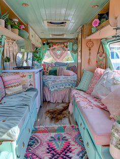 the interior of an rv decorated in pastel colors and rugs, including pillows