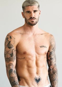 a shirtless man with tattoos on his chest