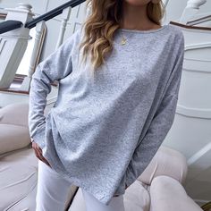 The EMES SHOP sweatshirt is detailed with a casual boat neck line that can be worn as one shoulder. Features a drop shoulder. solid color. long sleeves. and an oversized fit. Pair it with white trousers and heels for an easygoing look.MATERIAL:100% Soft Poly MEASUREMENTS:Product Length 25"-27"in Small | Bust & Hem Width : 44"-46"in Medium| Bust & Hem Width : 46"-48"in Large| Bust & Hem Width : 48"-50"in XL| Bust & Hem Width : 50"-52"in White Trousers, Women Long Sleeve Tops, Women Wholesale, Casual Tops For Women, Basic Tops, Top Women, Grey Long Sleeve, Boat Neck, Long Tops