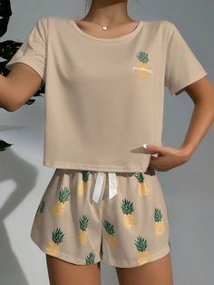 Effortlessly embrace summer vibes with our vibrant Pineapple Print Tee And Shorts Set. Express your style through the engaging letter and fruit and vegetable pattern. This 2-piece ensemble offers a relaxed regular fit, adorned with charming knot detail. Short sleeves and slight stretch fabric ensure comfort in every move. Ideal for sunny days and casual outings. Features: Pattern Type: Letter, Fruit and Vegetable Type: Short Sets Details: Knot Sleeve Length: Short Sleeve Fit Type: Regular Fit N Casual Sleepwear With Fruit Print For Loungewear, Cute Relaxed Fit Summer Sets, Trendy Short Summer Sleepwear, Cute Summer Vacation Sleepwear, Cute Short Tops For Vacation, Summer Relaxed Fit Pajama Shorts For Leisure, Summer Pajama Shorts With Relaxed Fit For Leisure, Comfortable Short Sleeve Sets For Summer, Comfortable Short Sleeve Summer Sets