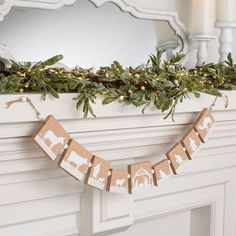 the garland is hanging on the fireplace mantle