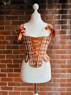 Get your own high quality historically inspired corset! It will shape your body magically without restricting your movement or being uncomfortable. Made out of cotton and linen, the corset is highly breathable and lightweight to wear, but still solid enough to give your waist a dramatic shape and your chest the lift we all love. For the perfect fit you can adjust the stays with the lacing in the back, the front and with the bows on the shoulder straps. All my corsets are made with love and with a very high level of detail. To provide sturdiness and comfort at the same time, both steel and synthetic whalebone are used for the boning. Whilst wearing, it will overtime mold to your bodyshape which results into an even more unique, perfectly fitting garment. Please pay attention to the sizes! T High Level, Women's Costumes, To Do List, Perfect Fit, Favorite Outfit, Plaid, Art Collection, Cute Outfits, Bathing Beauties