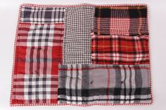 four different colors of plaid fabric on a white tablecloth with red, black and grey checkered squares