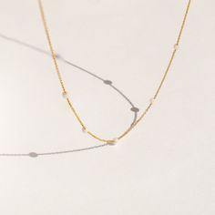 Handmade with genuine opals, our Opal Station Necklace radiates iridescent twinkles at every angle, making it a one-of-a-kind piece. The minimalist design makes it easy to wear with any outfit, and the adjustable chain ensures a perfect fit. Whether you're treating yourself or gifting someone special, this necklace is sure to be cherished for years to come. Material: High Quality Solid 925 Sterling Silver Finish: Sterling Silver ∙ 18K Gold Featuring ~3mm Opal Gemstones stationed around a dainty Minimalist Yellow Gold Opal Jewelry, Elegant Opal Necklaces With Adjustable Chain, Minimalist Opal Jewelry With Delicate Chain, Minimalist White Necklaces With Satellite Chain, Minimalist Adjustable Pearl Chain Necklace, Minimalist Gold Opal Jewelry, Delicate Gold Opal Necklace, Minimalist White Necklace With Satellite Chain, Minimalist White Jewelry With Box Chain