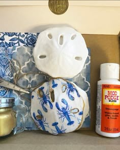 some crafting supplies are sitting on a counter top, including a mask and glue