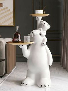 a white bear holding a tray with drinks on it