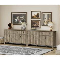 a living room scene with focus on the sideboard and pictures hanging on the wall