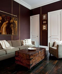 a living room filled with furniture and pictures on the wall above it's coffee table