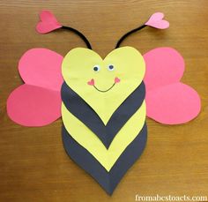 a paper bee with hearts on its wings