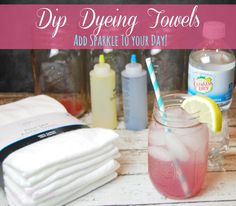 a mason jar filled with pink liquid next to several dispensers and towels