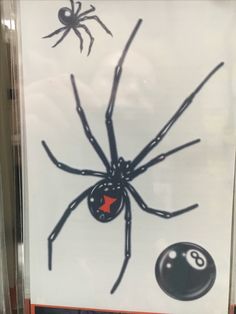 a spider and pool balls on display in a store window