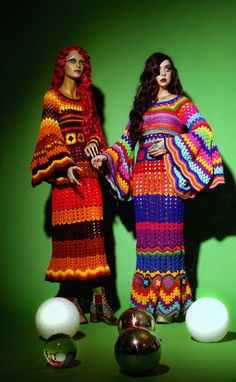 two women standing next to each other in colorful clothing