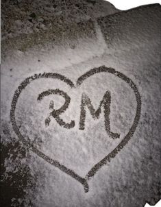 the word ms is written in the snow with a heart on it's side