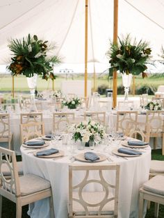 the tables are set up with white linens and blue napkins for an elegant wedding reception