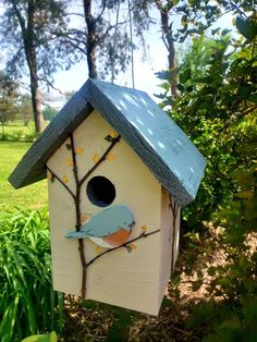 a bird house hanging from a tree branch