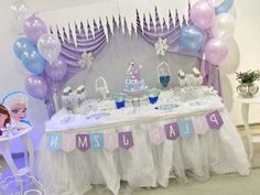 a frozen princess birthday party with balloons, cake and dessert table set up for an event