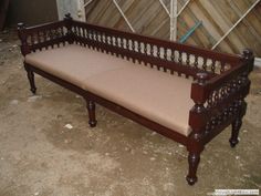 a wooden bench sitting in the middle of a room