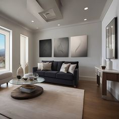 a living room filled with furniture and a large window overlooking the mountains in the distance