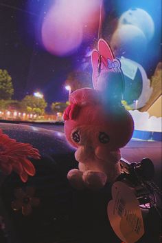 a stuffed animal sitting on the dashboard of a car