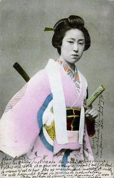 an old photo of a woman in traditional japanese dress holding a bottle and two baseball bats