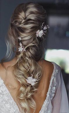 the back of a woman's head with flowers in her hair