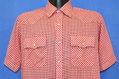 Chest 22.5 in.  Length 29 in.   Shoulder  in.  Tag Says: Montgomery Ward, 65% Polyester, 35% Cotton, M  This sweet vintage western shirt comes decked out in a red gingham pattern, and it also features pearl snap closures and two chest pockets. The pockets have scalloped flaps that match the western style yokes on the front and back of the shirt.   Comments: Fits like a modern men's medium, several small holes on the back and front near the bottom and in the left underarm when wearing, see pics Red Western Style Tops For Ranch, Western Style Summer Shirt With Snap Buttons, Vintage Red Tops For Rodeo, Fitted Cotton Shirt For Country Events, Red Top For Summer Rodeo, Red Summer Top For Rodeo, Summer Rodeo Shirt With Pockets, Western Style Red Tops For Spring, Western Red Tops For Spring