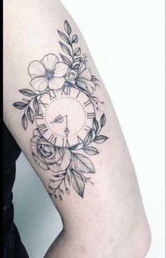 a woman's arm with a clock and flowers on it