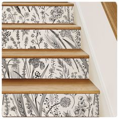 the stairs are decorated with floral wallpaper and decorative stickers for decorating them