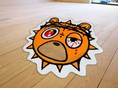 the floor is made up of wood and has a sticker with an image of a bear's head on it