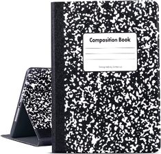 a black and white composition book next to an ipad case with the title composition book printed on it