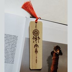 a bookmark with an image of a dream catcher hanging from it's side