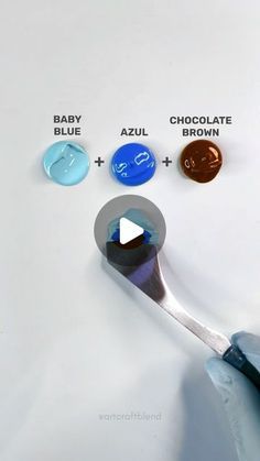 a spoon with different colors of paint on it and the words baby blue, azzul, chocolate brown