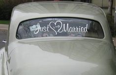 an old car with just married sticker on it