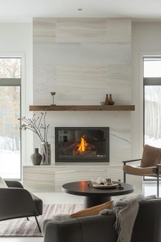 a living room filled with furniture and a fire place in the middle of the room