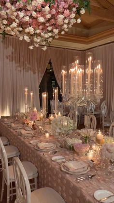 a long table is set with candles and plates for dinner guests to enjoy the meal