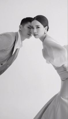 a man and woman posing for a photo in black and white, with their arms around each other