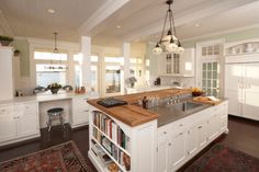 a large kitchen with an island in the middle