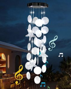 a chandelier with musical notes hanging from it's sides and stars in the middle