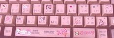 the keyboard has many stickers on it and is pink with white letters that spell out hello kitty