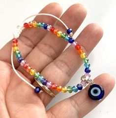 Evil Eye Charm On Seven Chakra Rainbow Glass Bead Adjustable Bracelet Wax Cord | eBay Handmade Adjustable Multicolor Crystal Bracelet, Multicolor Beaded Evil Eye Bracelet Spiritual, Multicolor Beaded Evil Eye Bracelet, Handmade Multicolor Crystal Bracelet For Beach, Bohemian Round Rainbow Bracelets, Adjustable Multicolor Evil Eye Beads, Adjustable Multicolor Crystal Bracelet With Spacer Beads, Multicolor Evil Eye Friendship Bracelets With Round Beads, Adjustable Rainbow Beaded Crystal Bracelet