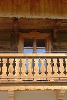 a balcony with wooden balconies and wrought iron railing