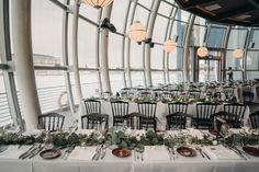 the tables are set with place settings for an elegant wedding reception on board a cruise ship