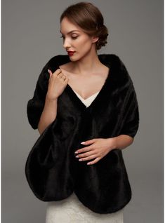 a woman wearing a black fur coat