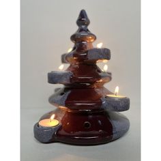 a small christmas tree made out of candles