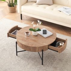 a coffee table with an open drawer underneath it on a rug in a living room