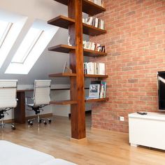 a living room filled with furniture and a flat screen tv sitting on top of a wooden floor