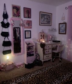 a bedroom decorated in pink and black with pictures on the wall, leopard print rug