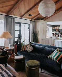 a living room filled with furniture and lots of windows