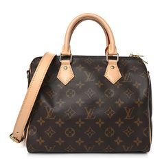 This is an authentic LOUIS VUITTON Monogram Speedy Bandouliere 25. This classic shoulder bag is crafted of signature Louis Vuitton monogram toile canvas. The bag features vachetta cowhide leather rolled top handles, an optional shoulder strap, and polished gold hardware. The top zipper opens to a cocoa brown fabric interior with a hanging zipper pocket. Speedy Bandouliere 25, Louis Vuitton Monogram Bag, Louis Vuitton Crossbody Bag, Speedy Bandouliere, Louis Vuitton Crossbody, Louis Vuitton Empreinte, Louis Vuitton Vernis, Leather Roll, Cocoa Brown