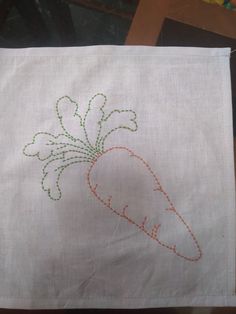 a white cloth with a carrot embroidered on it